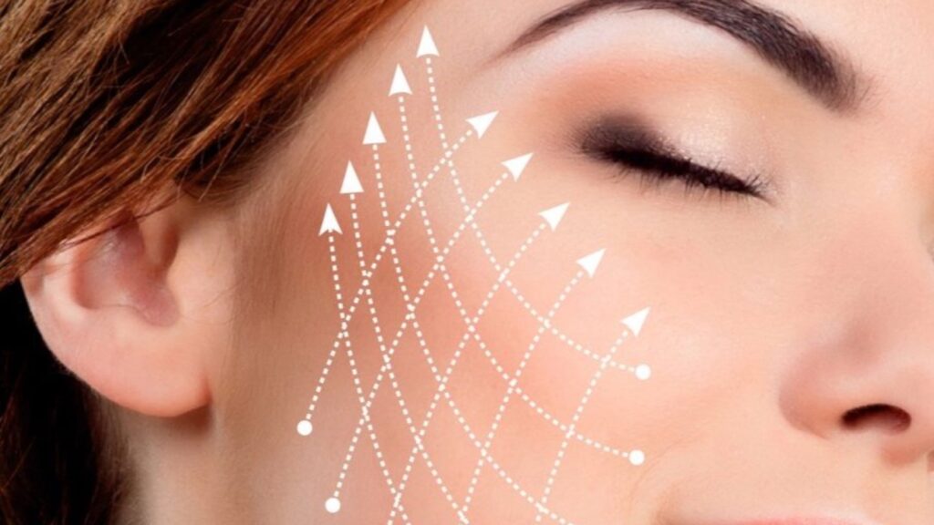 Close-up of a woman's cheek with a pattern of dotted lines drawn across it