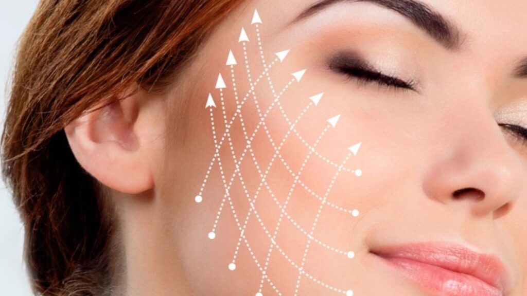 Close-up of a woman's cheek, eyes closed, with a pattern of dotted lines drawn across it